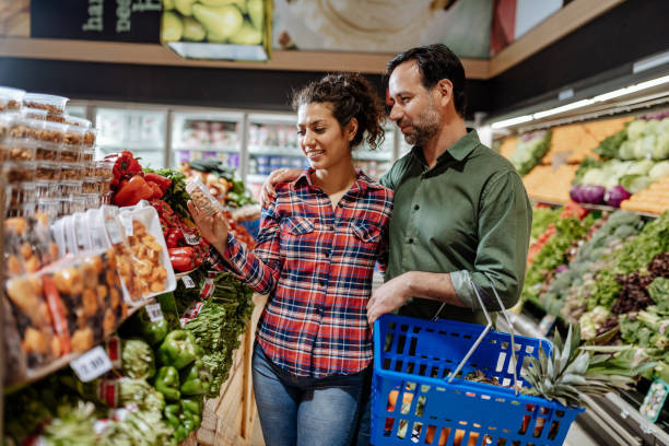Latino couple buying vegan food stock photo
