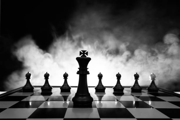 шахматный король и пешки на шахматной доске - intelligence set armed forces competitive sport стоковые фото и изображения