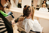 Close-up of a hairdresser dying a female hair