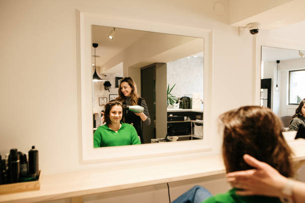 istock Hair stylist using a hair dryer 1389887022