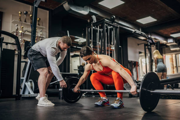 istock Woman training with personal trainer 1389888197