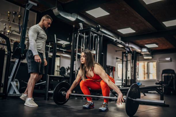 istock Woman training with personal trainer 1389888352