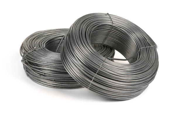 istock Two coils of galvanized wires lying on white background. 1389888652