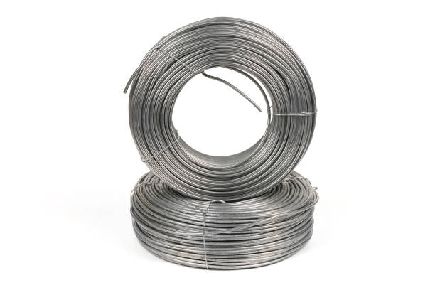 istock Two coils of galvanized wires lying on white background. 1389888746