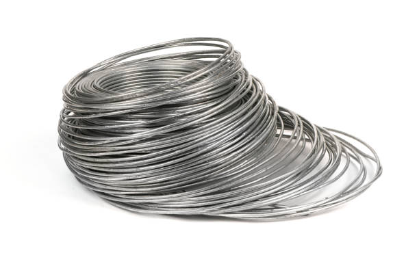 istock Coil of galvanized wires lying on white background. High resolution photo. 1389888795