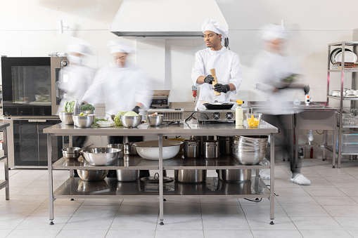 istock Chef cooks working in professional kitchen 1389888983