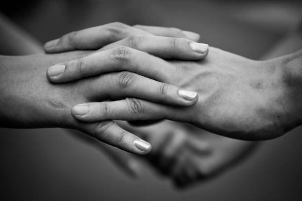 istock Holding hands - love never fails 1389890237