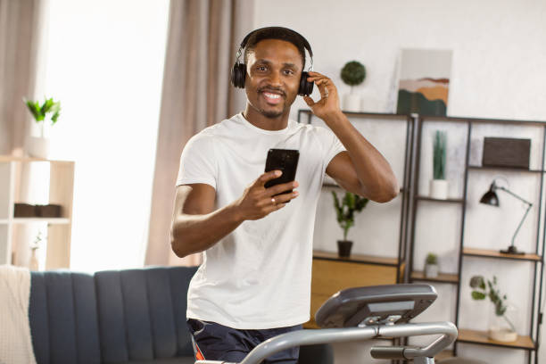 istock Young african american man jogging on the modern treadmill 1389890666