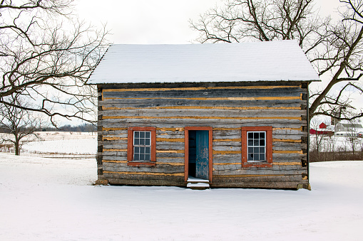 Log Cabin with Open door in snow