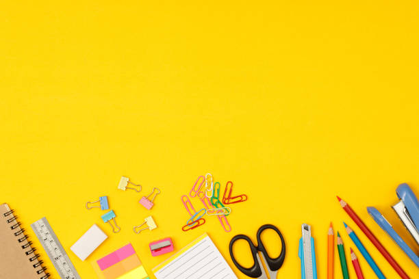 istock Top view notebooks and accessories studying in the library at school yellow background idea education 1389894353