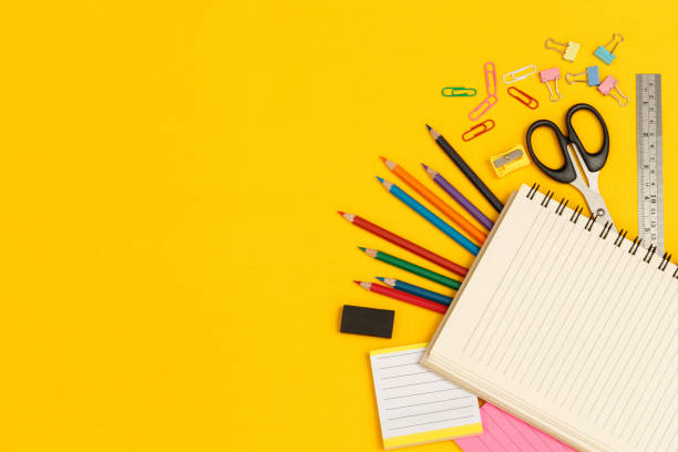 istock Top view notebooks and accessories studying in the library at school yellow background idea education 1389894363
