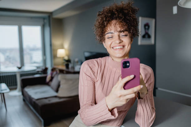istock A young mixed race woman is using a mobile phone 1389894926
