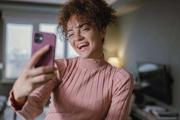 istock A young mixed race woman is using a mobile phone 1389895115