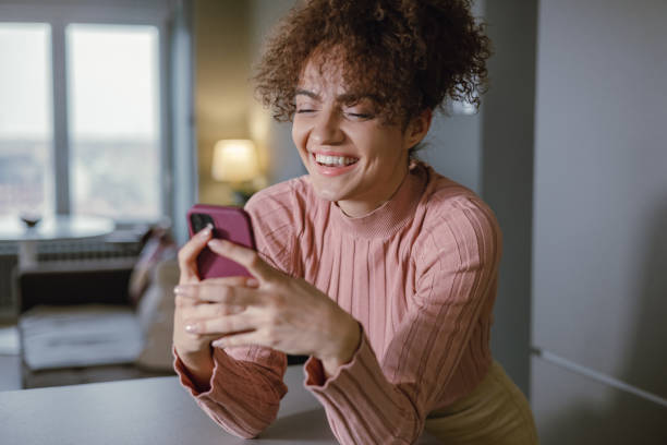 istock A young mixed race woman is using a mobile phone 1389895433