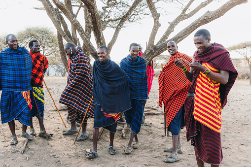 October 8, 2020 - Maasai people wearing traditional clothes meeting tourists and having discussion by having fun and laughing in Tanzania, East Africa