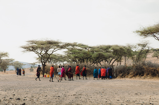 October 8, 2020 - Maasai people wearing traditional clothes walking into their village in Tanzania, East Africa