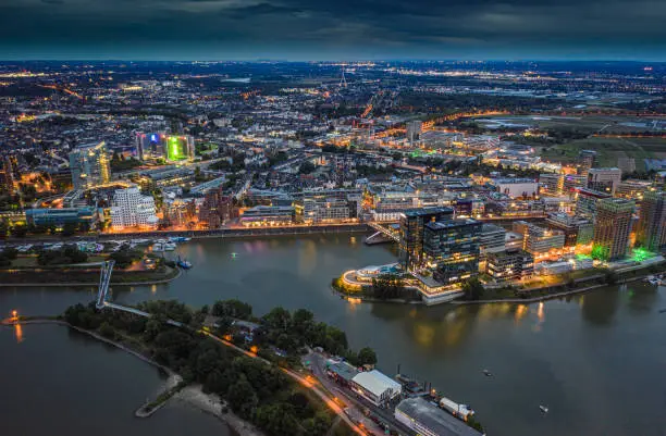 Aerial view of the Media Harbor in Düsseldorf at night. Illuminated buildings. Germany - Europe