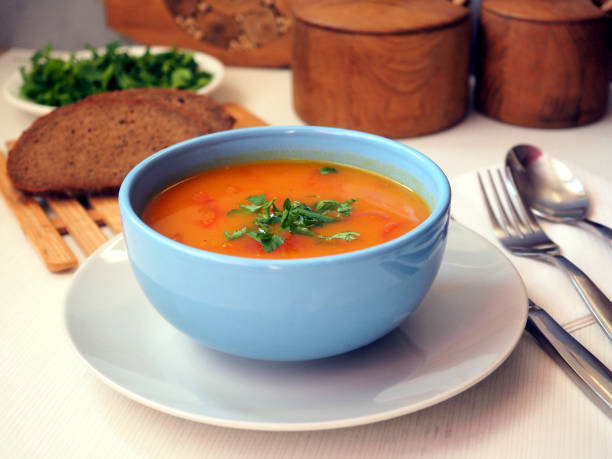 istock Orange pumpkin puree soup in a blue ceramic bowl. Rye bread. dinner serving 1389896972