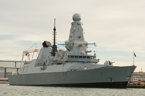 Royal Navy destroyer moored in dockyard at Portsmouth, Hampshire, England