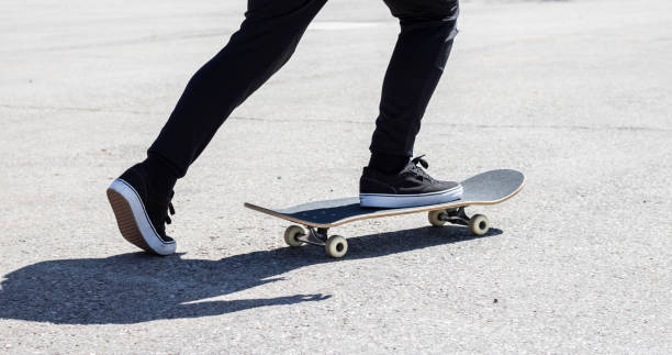 istock Close-up of legs propelling a skateboard 1389897990
