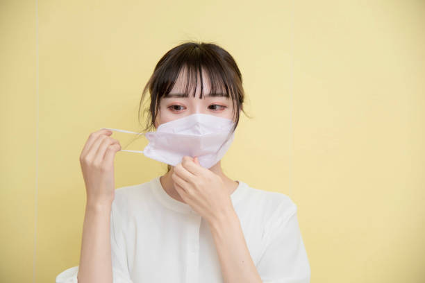istock masked woman 1389898495