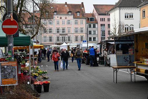 Konstanz, Germany, March 29, 2022 - Unidentified people at the weekly market St. Stephen's Square in Constance