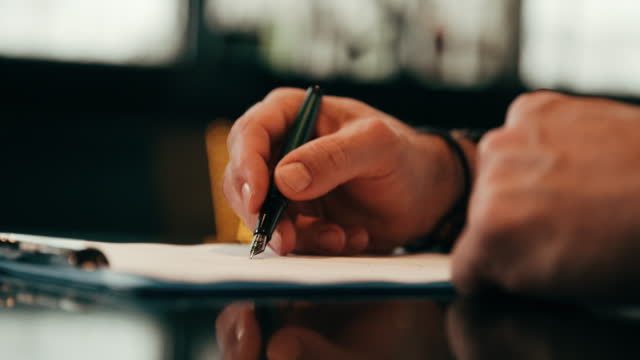 Signing a document on a clipboard. Filling paperwork form document