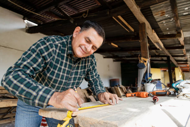 istock Mexican carpenter working in his workshop-Smiling mature man working in carpentry workshop-Happy carpenter working 1389903439