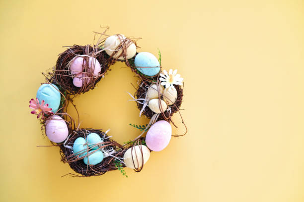 istock Easter Decoration with Easter Wreath and Eggs on Yellow Background 1389903647