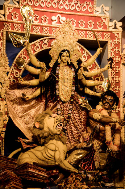 istock Mother Goddess devi with bow and arrows, conch shell, sword, shield and lion in durga puja or durga ashtami. 1389903949