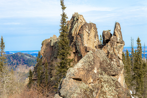 Kitayskaya Stenka is rock pillar against blue sky in the Stolby Nature Reserve in Krasnoyarsk, Russia
