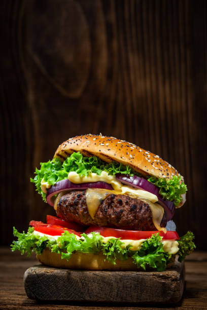 istock Cheese Burger with Meat on Wooden Copy Space Background 1389905265