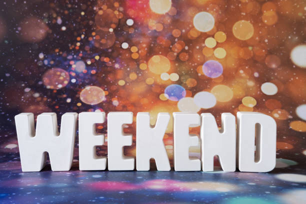 istock Word Weekend made from white concrete letters on the multicolor background 1389905448