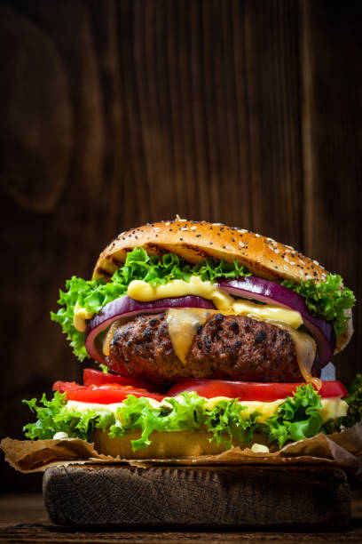 istock Cheese Burger with Meat on Wooden Copy Space Background 1389905596