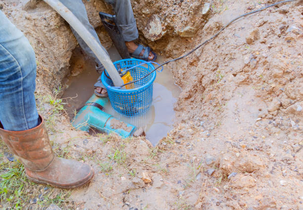 istock worker male repair plumbing broken plastic pipe in the hole with water flow 1389906643