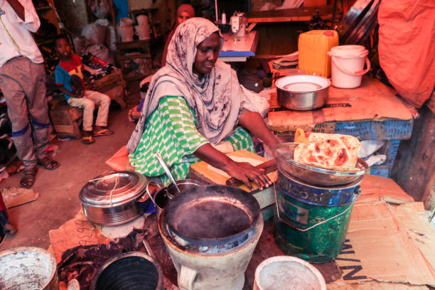 Local Woman making Pita Bread on the Food Market Hargeisa, Somaliland - November 10, 2019: Local Woman making Pita Bread on the Food Market hargeysa photos stock pictures, royalty-free photos & images