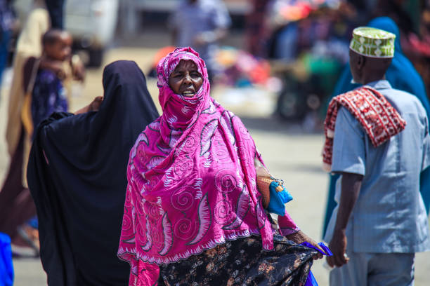 Muslim Woman in Hijab walking on the Capital Streets Hargeisa, Somaliland - November 10, 2019: Muslim Woman in Hijab walking on the Capital Streets hargeysa photos stock pictures, royalty-free photos & images