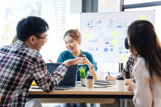 istock Young colleagues having great business conversations in a modern coworking office. Teamwork concept. Horizontal blurry background. Fireworks. 1389913288