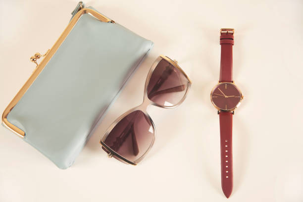istock woman bag with sunglasses on the pink table 1389916775