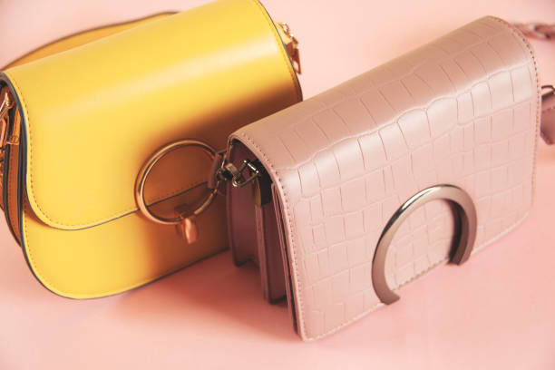 istock color handbags on the pink table background 1389916781