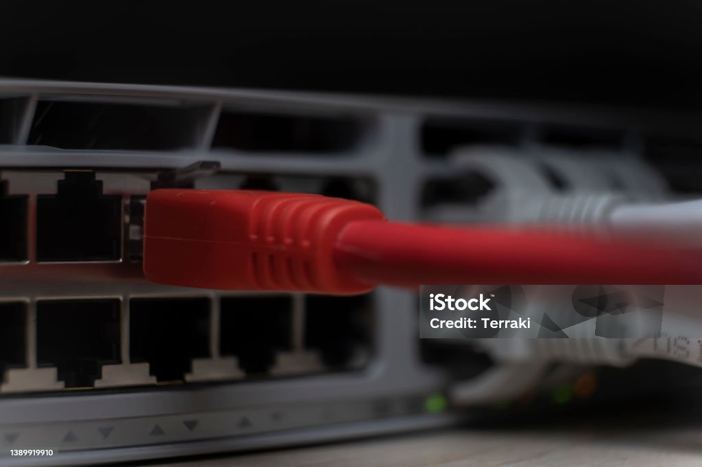 Plugging red color ethernet  cable into the  network switch port Plugging red color ethernet  cable into the  network switch port,connection status Cable Stock Photo