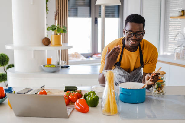 istock Man cooking pasta at home 1389922156