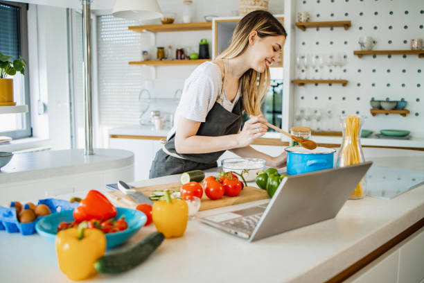 istock Confident young woman cooking 1389922165