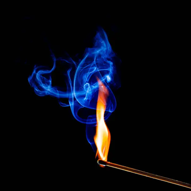 flame and smoke of a matchstick  on black background