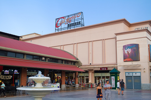 Stores and Calypso entertainment complex  at Asiatique at Chao Praya river in Bangkok in early sunset. in foreground some people are walking. Asiatique is promenade area with restaurants in southern Bangkok