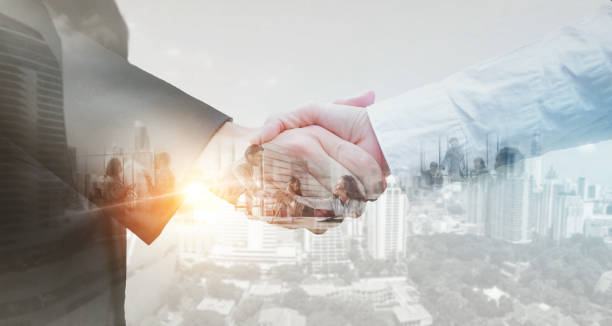 istock Business partner shaking hands in city with double exposure of interface data. Teamwork concept. 1389923210