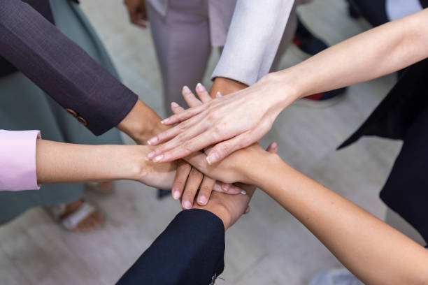 istock Close-up of hands People with joined hands as a team. 1389924983
