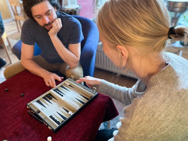 Wooden backgammon board with dice and pieces close up