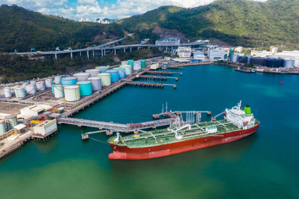 Tank ship loading unloading oil and gasoline at Commercial dock in sea