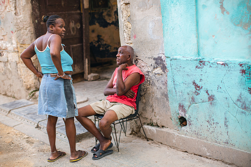 Old couple is talking in front of their house in Havana, Cuba
